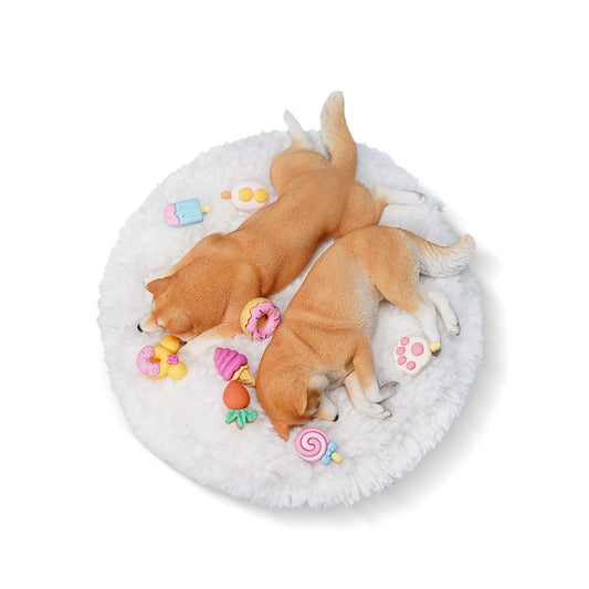 A detailed resin model of a sleeping Shiba Inu dog on a fluffy white bed, surrounded by colorful toy replicas like a carrot, ice cream cone, donut, and paw print. The model captures the serene essence of a Shiba Inu with its realistic fur texture and lifelike posture, ideal for collectors and dog enthusiasts.