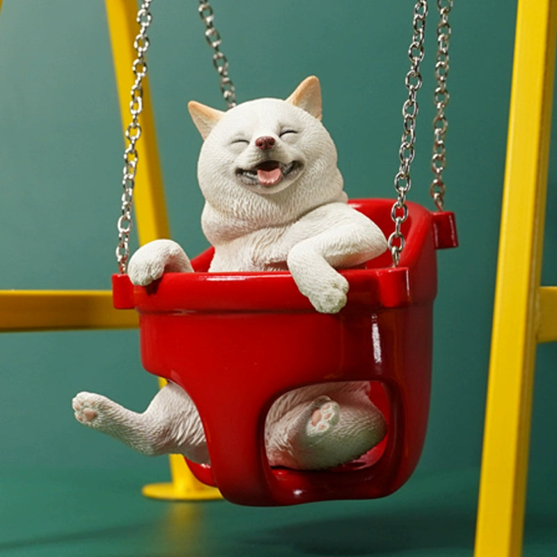 1/6 scale Shiba Inu dog figurines sitting in a red swing, mounted on a yellow frame. These lifelike models feature the cheerful expressions of Shiba Inus, detailed fur textures, and adorable poses. Perfect for collectors and dog lovers, these figurines bring a touch of playfulness and charm to any display setting.