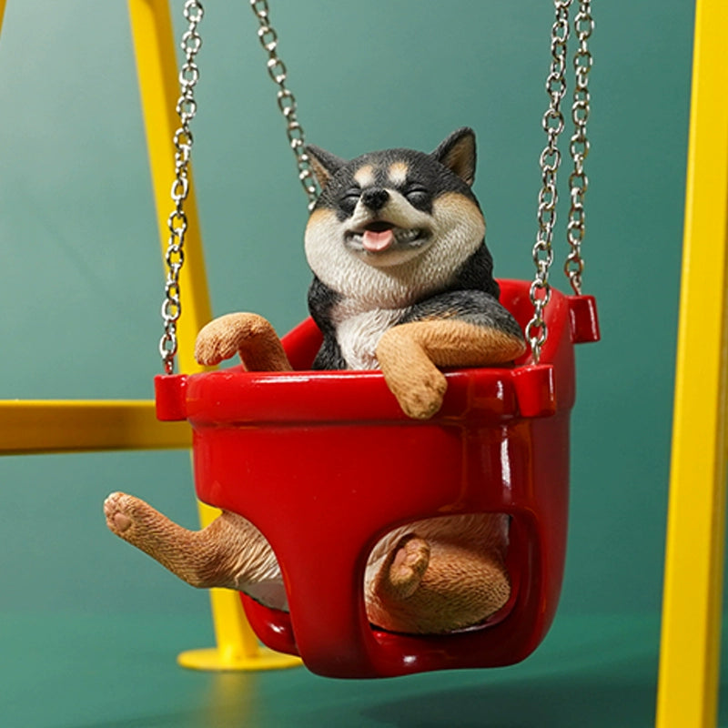 1/6 scale Shiba Inu dog figurines sitting in a red swing, mounted on a yellow frame. These lifelike models feature the cheerful expressions of Shiba Inus, detailed fur textures, and adorable poses. Perfect for collectors and dog lovers, these figurines bring a touch of playfulness and charm to any display setting.