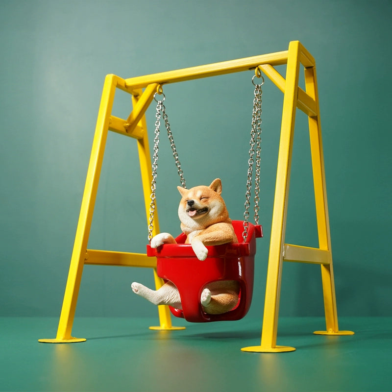 1/6 scale Shiba Inu dog figurines sitting in a red swing, mounted on a yellow frame. These lifelike models feature the cheerful expressions of Shiba Inus, detailed fur textures, and adorable poses. Perfect for collectors and dog lovers, these figurines bring a touch of playfulness and charm to any display setting.