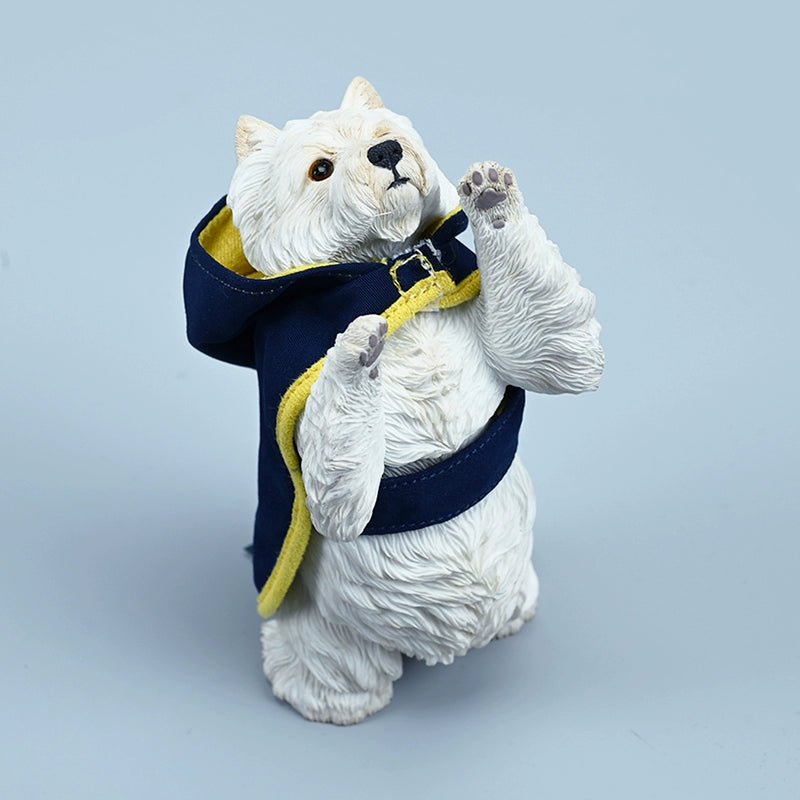 A figurine of a West Highland White Terrier standing on its hind legs, dressed in a blue hoodie with yellow trim. The detailed and lifelike model captures the dog's playful and curious nature, making it an adorable addition to any collection.