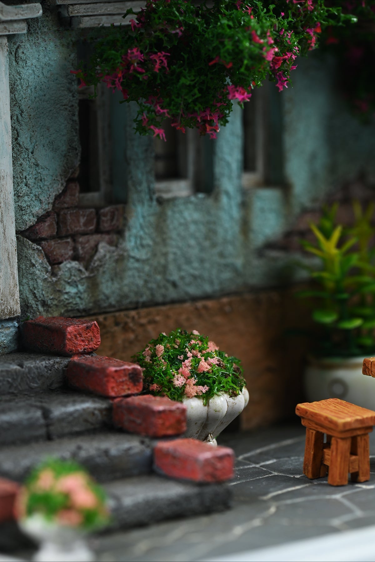 A detailed and charming art relief picture frame model featuring a white cat reaching up towards a window, surrounded by a beautifully crafted miniature garden with flowers, plants, and a rustic table with chairs. Perfect for adding a touch of whimsy and artistic flair to any room.