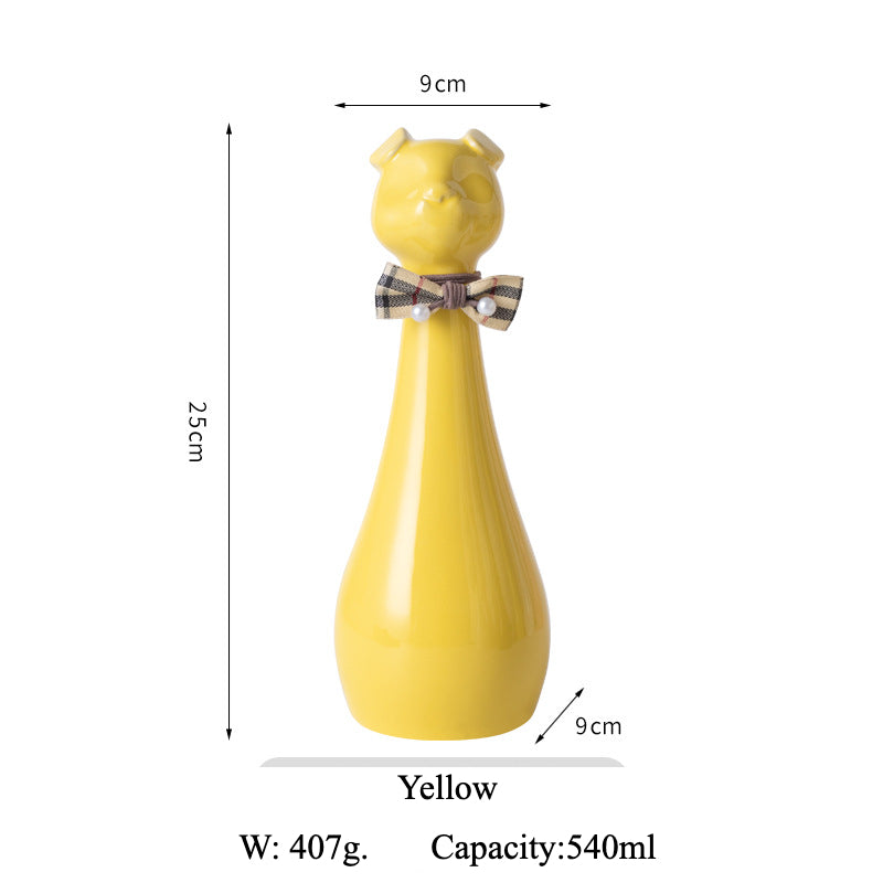 Yellow ceramic cat-shaped pet cremation urn with a glossy finish, featuring a stylish cat figure with a bow tie on a slender base, ideal for North American pet owners. This handcrafted urn provides secure ashes storage, perfect for home memorial display on mantels or shelves, with a vibrant yellow hue and elegant design.