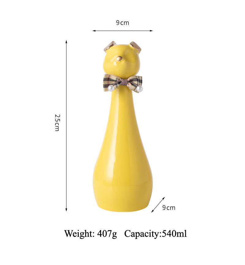 Yellow ceramic cat-shaped pet cremation urn with a glossy finish, featuring a stylish cat figure with a bow tie on a slender base, ideal for North American pet owners. This handcrafted urn provides secure ashes storage, perfect for home memorial display on mantels or shelves, with a vibrant yellow hue and elegant design.
