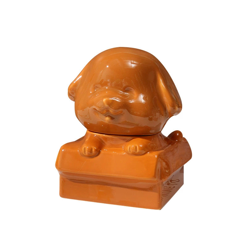Orange ceramic dog-shaped pet urn with a glossy finish, featuring a cute dog figure on a square base, ideal for North American pet owners. This handcrafted memorial urn securely stores pet ashes, perfect for home display on mantels or shelves, offering a dignified tribute with its vibrant color and unique design.