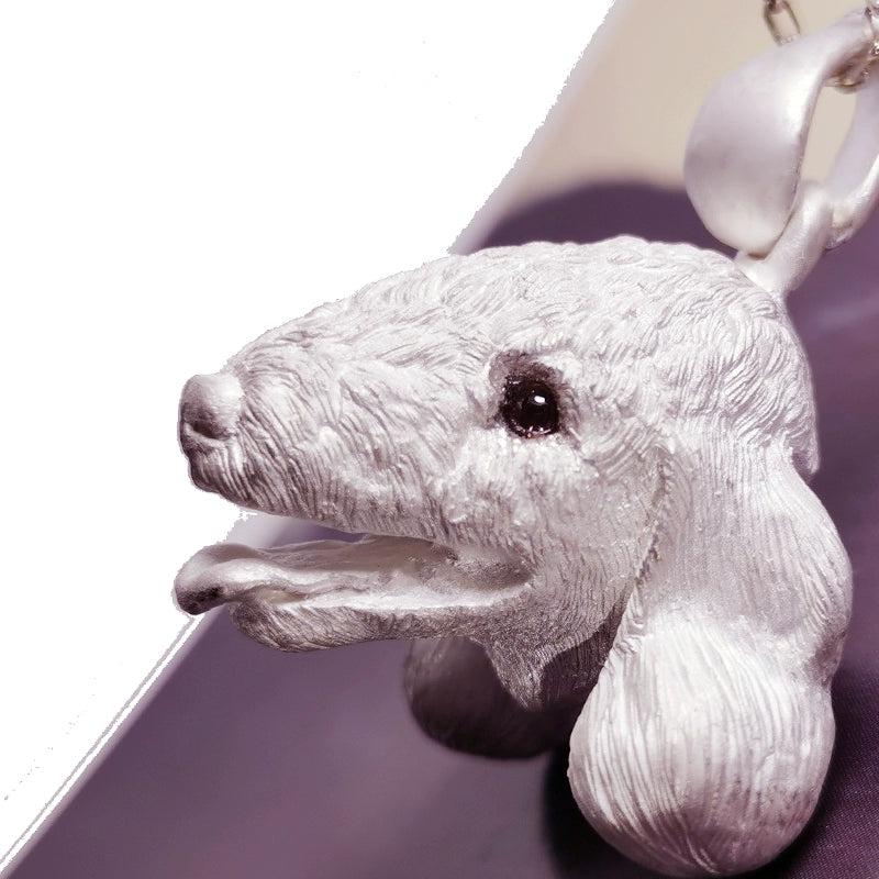 Close-up image of the Chameleon Bellington Pendant, showcasing intricate handcrafted details in 925 silver with gemstone eyes. The pendant captures the essence of the Bellington dog, highlighting fine fur texture and expressive features. Available in silver or antique black finish.