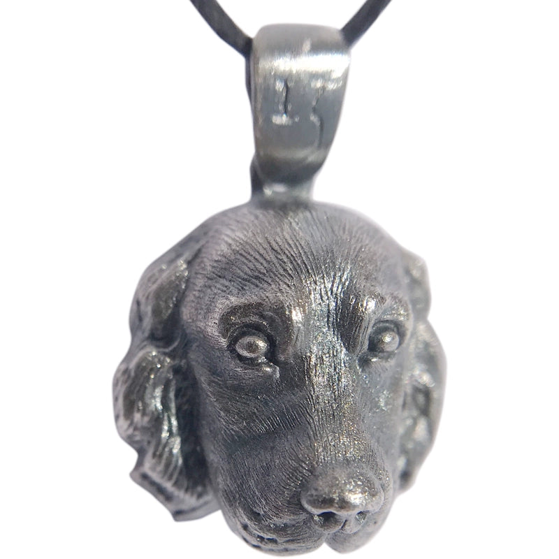 Close-up of a handcrafted Cocker Spaniel pendant in 925 silver, featuring detailed sculpting and gemstone eyes. Available in silver and antique black finishes, with options for custom engraving to create a personalized pet memorial.