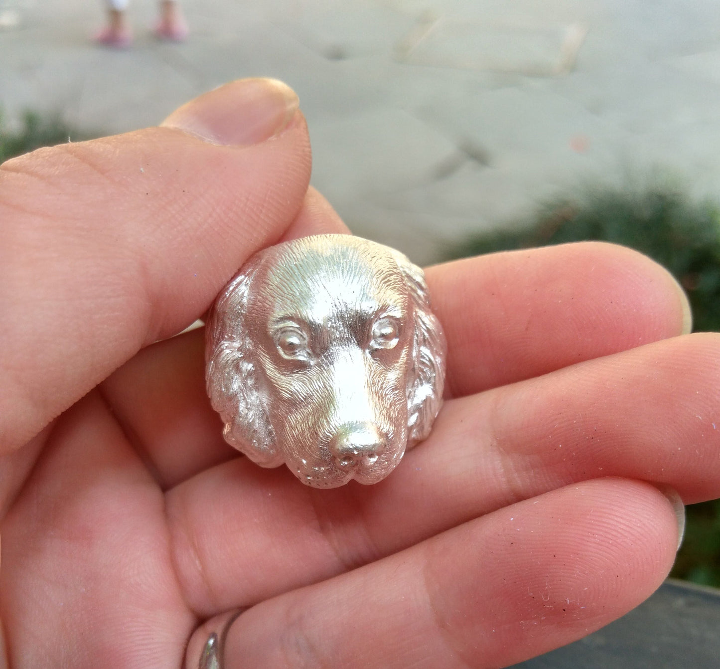 Close-up of a handcrafted Cocker Spaniel pendant in 925 silver, featuring detailed sculpting and gemstone eyes. Available in silver and antique black finishes, with options for custom engraving to create a personalized pet memorial.