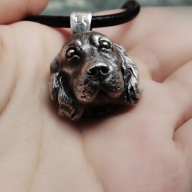 Close-up of a handcrafted Cocker Spaniel pendant in 925 silver, featuring detailed sculpting and gemstone eyes. Available in silver and antique black finishes, with options for custom engraving to create a personalized pet memorial.