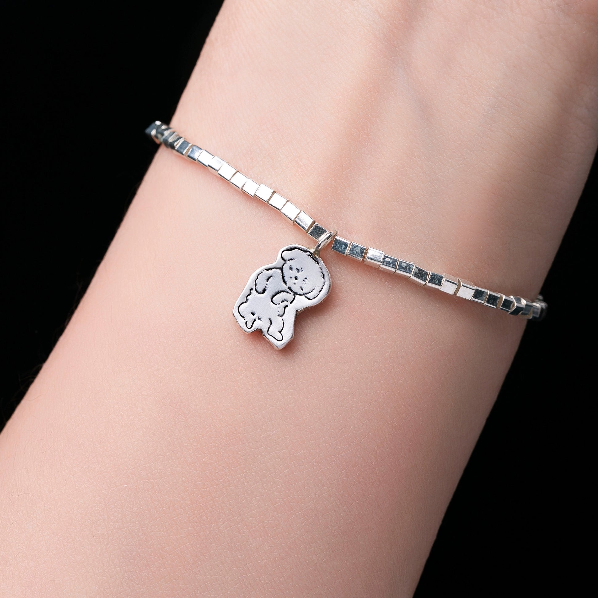 Close-up of a Custom Pet Portrait Bracelet, showcasing a detailed 925 silver charm with a pet's face engraving. This personalized, handmade bracelet serves as a keepsake or memorial piece, capturing the unique features of your pet based on provided photos, highlighting the craftsmanship and sentimental value.