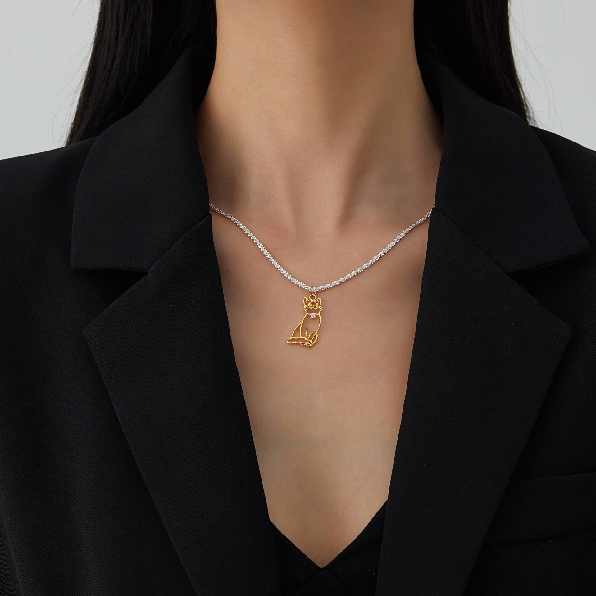 A delicate custom pet portrait necklace featuring a 925 silver pendant with a detailed outline of a cat. The necklace is elegantly displayed on a white jewelry stand, highlighting its intricate design and craftsmanship. This personalized pet jewelry piece serves as a beautiful keepsake for pet lovers, capturing the essence of their furry friends in silver.