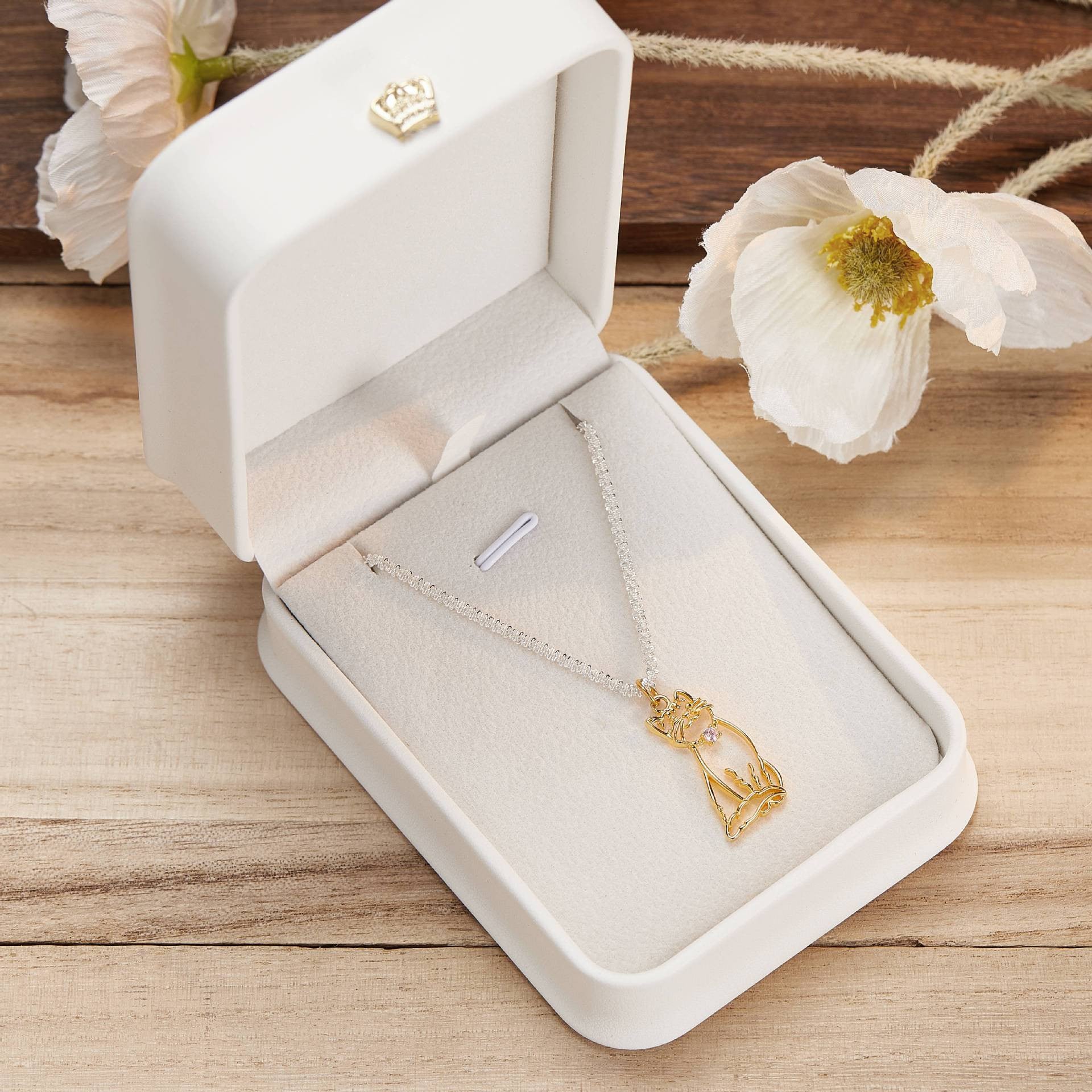 A delicate custom pet portrait necklace featuring a 925 silver pendant with a detailed outline of a cat. The necklace is elegantly displayed on a white jewelry stand, highlighting its intricate design and craftsmanship. This personalized pet jewelry piece serves as a beautiful keepsake for pet lovers, capturing the essence of their furry friends in silver.