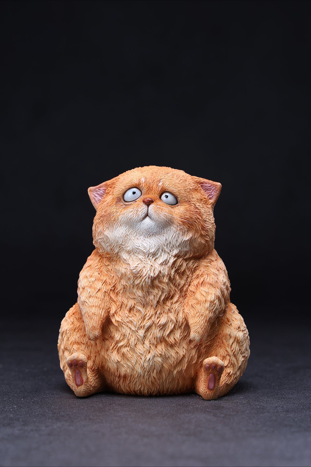 A set of three adorable Dazed Cat Model Ornaments featuring lifelike details and a cute, dazed expression. The models come in three colors: calico, gray, and orange. Each cat is depicted in a seated position, showcasing intricate fur textures and expressive eyes. Perfect for cat lovers and collectors.