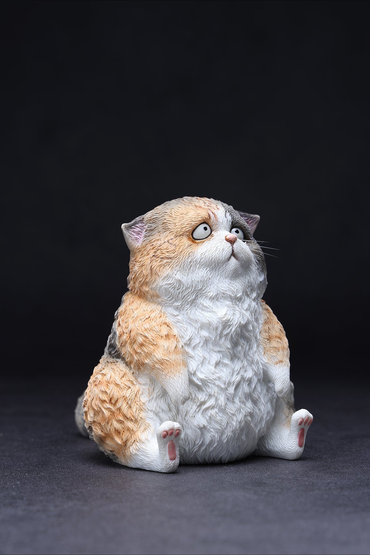 A set of three adorable Dazed Cat Model Ornaments featuring lifelike details and a cute, dazed expression. The models come in three colors: calico, gray, and orange. Each cat is depicted in a seated position, showcasing intricate fur textures and expressive eyes. Perfect for cat lovers and collectors.