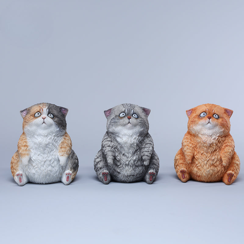 A set of three adorable Dazed Cat Model Ornaments featuring lifelike details and a cute, dazed expression. The models come in three colors: calico, gray, and orange. Each cat is depicted in a seated position, showcasing intricate fur textures and expressive eyes. Perfect for cat lovers and collectors.