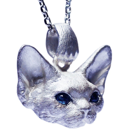 This image showcases the Devon Bobcat Silver Pendant, a beautifully handcrafted pet memorial necklace made from 925 sterling silver. The pendant features lifelike details of the Devon Bobcat, with carefully set gemstone eyes that add a unique touch. Due to the handcrafted nature, each piece has slight variations, making it one-of-a-kind. Custom engraving is available to personalize the pendant as a cherished keepsake. The image highlights the fine craftsmanship and delicate details that make this pendan