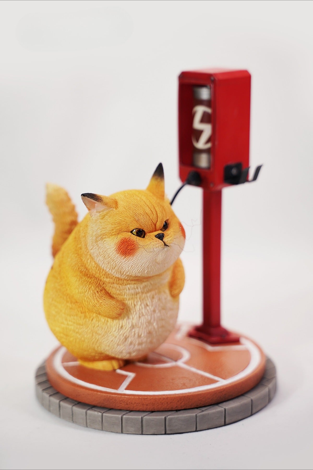 This ElectroCat Charging Station Figurine features a cute cat with a charging pump made from high-quality vinyl. The charging platform adds functionality, allowing the figurine to light up, making it a unique home decor piece and interactive collectible for cat lovers and collectors.