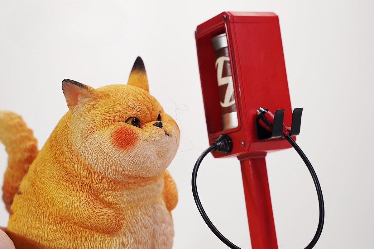This ElectroCat Charging Station Figurine features a cute cat with a charging pump made from high-quality vinyl. The charging platform adds functionality, allowing the figurine to light up, making it a unique home decor piece and interactive collectible for cat lovers and collectors.