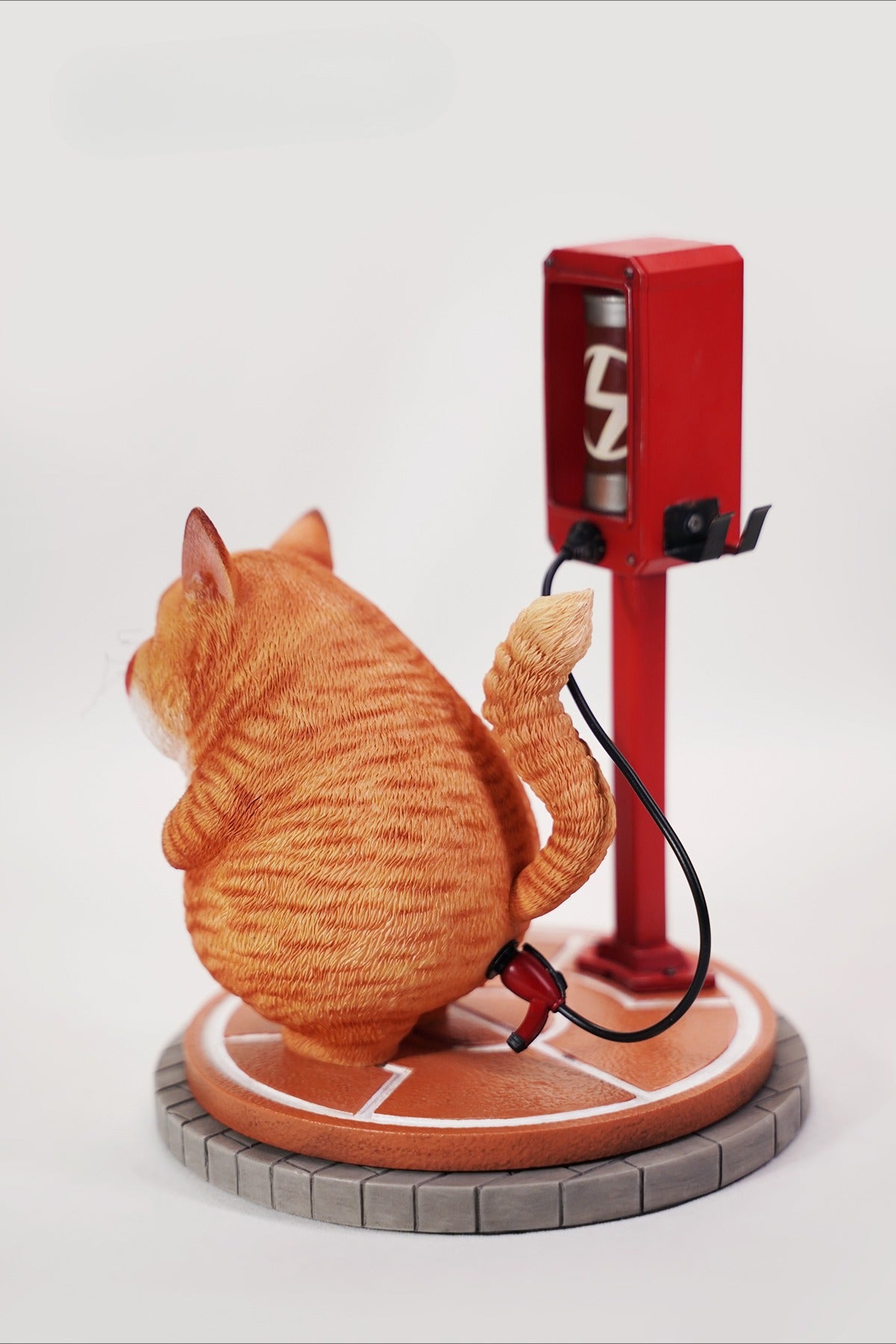 This ElectroCat Charging Station Figurine features a cute cat with a charging pump made from high-quality vinyl. The charging platform adds functionality, allowing the figurine to light up, making it a unique home decor piece and interactive collectible for cat lovers and collectors.