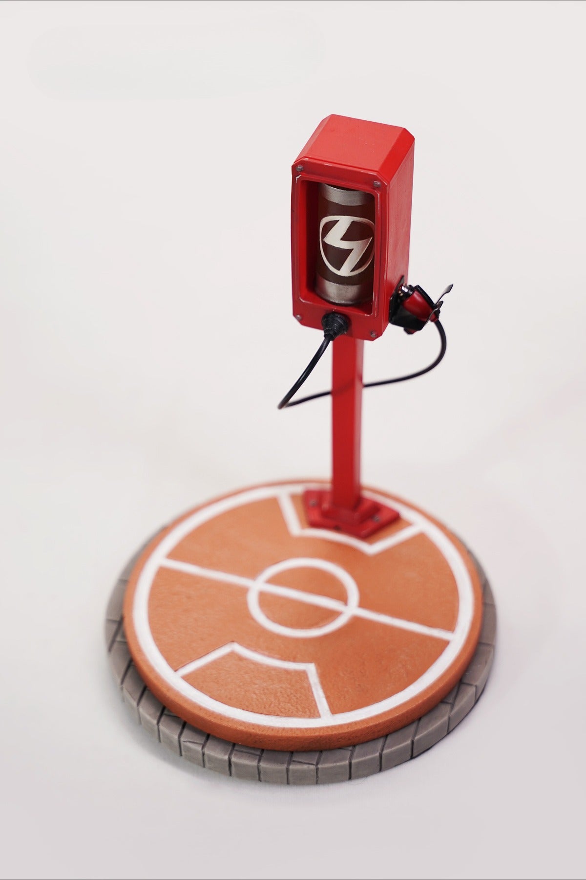 This ElectroCat Charging Station Figurine features a cute cat with a charging pump made from high-quality vinyl. The charging platform adds functionality, allowing the figurine to light up, making it a unique home decor piece and interactive collectible for cat lovers and collectors.