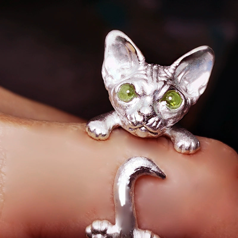 A handcrafted Sphynx cat pendant and ring set in 925 sterling silver, featuring customizable gemstone eyes and available in both silver and antique black finishes. This unique jewelry piece is perfect for Sphynx cat lovers and as a personalized pet memorial.