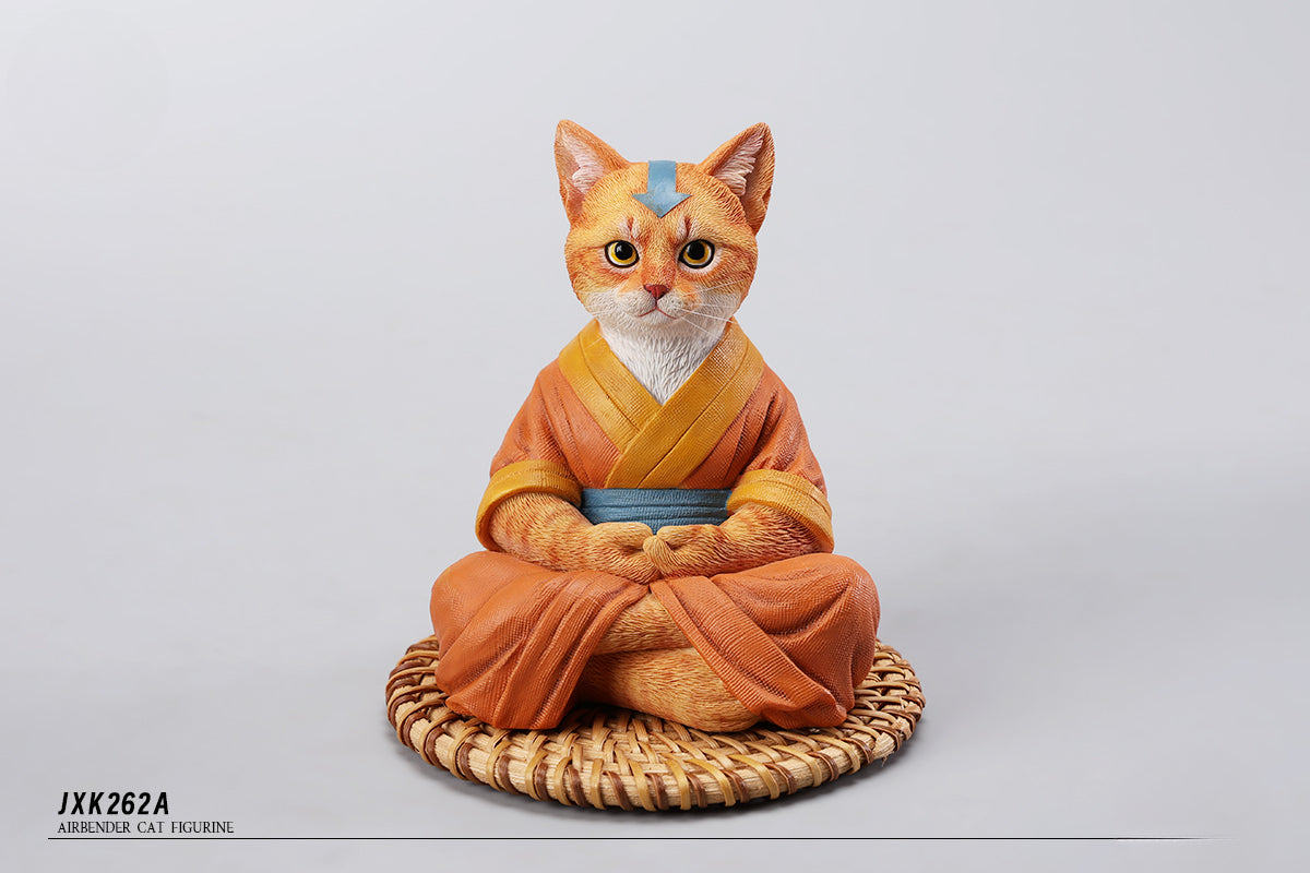 A handcrafted Airbender Cat Figurine in a meditative pose, dressed in an orange robe with a blue sash, sitting on a rattan-weaved cushion. This finely detailed resin sculpture captures the tranquility of mindfulness, perfect for cat lovers and meditation enthusiasts. An ideal collectible and decorative accent for any serene space.