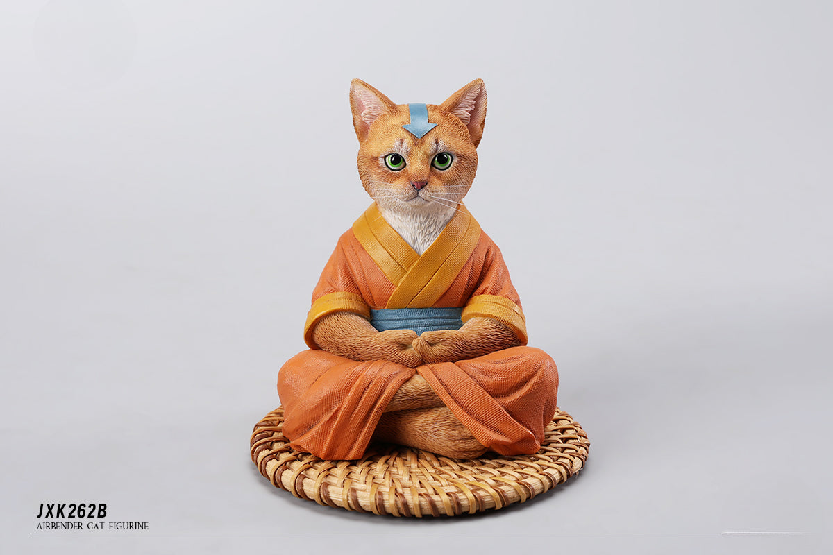 A handcrafted Airbender Cat Figurine in a meditative pose, dressed in an orange robe with a blue sash, sitting on a rattan-weaved cushion. This finely detailed resin sculpture captures the tranquility of mindfulness, perfect for cat lovers and meditation enthusiasts. An ideal collectible and decorative accent for any serene space.