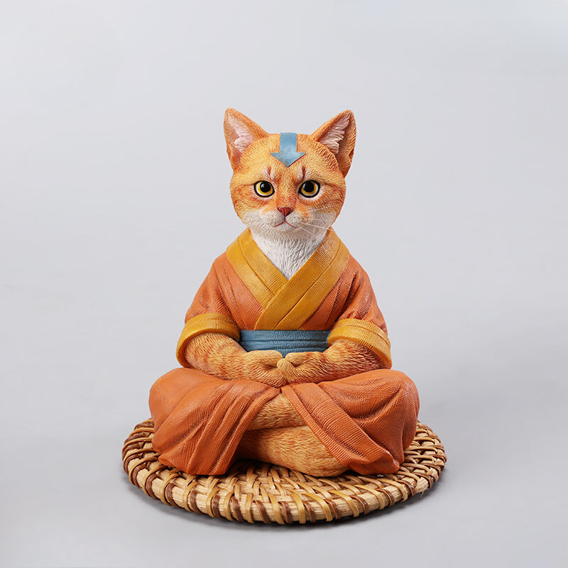 A handcrafted Airbender Cat Figurine in a meditative pose, dressed in an orange robe with a blue sash, sitting on a rattan-weaved cushion. This finely detailed resin sculpture captures the tranquility of mindfulness, perfect for cat lovers and meditation enthusiasts. An ideal collectible and decorative accent for any serene space.