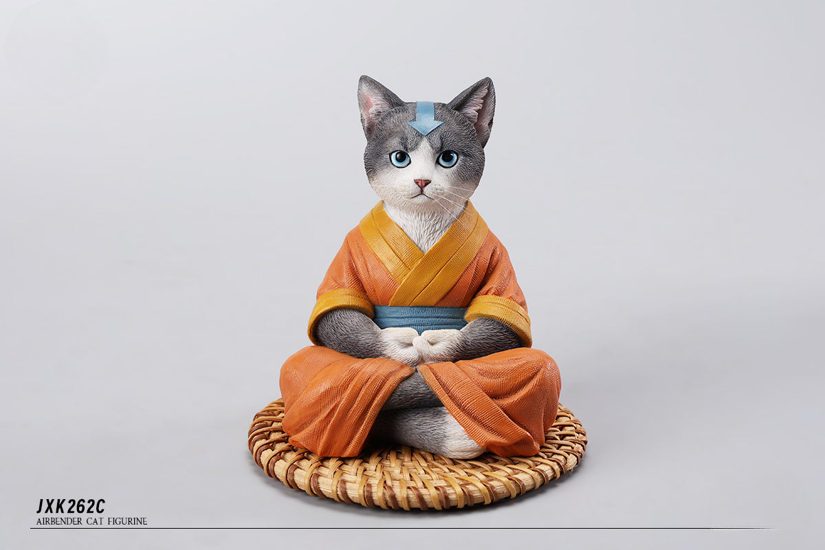 A handcrafted Airbender Cat Figurine in a meditative pose, dressed in an orange robe with a blue sash, sitting on a rattan-weaved cushion. This finely detailed resin sculpture captures the tranquility of mindfulness, perfect for cat lovers and meditation enthusiasts. An ideal collectible and decorative accent for any serene space.