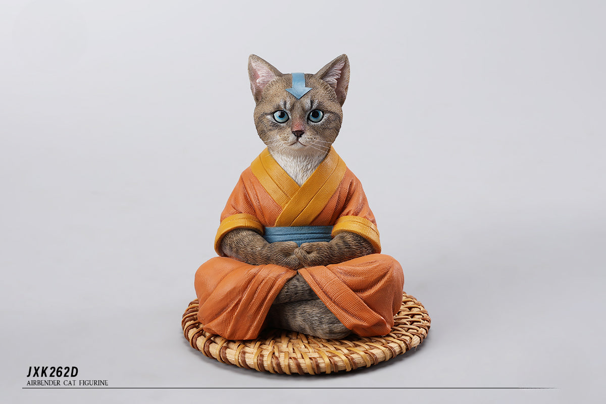 A handcrafted Airbender Cat Figurine in a meditative pose, dressed in an orange robe with a blue sash, sitting on a rattan-weaved cushion. This finely detailed resin sculpture captures the tranquility of mindfulness, perfect for cat lovers and meditation enthusiasts. An ideal collectible and decorative accent for any serene space.