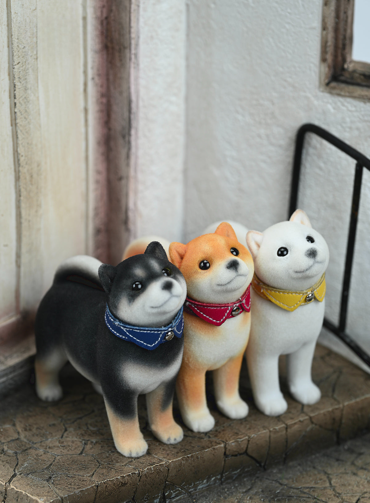 A set of three flocking Shiba Inu dog models in different colors - black, white, and tan. Each model features a realistic and adorable design with a collar in different colors: blue, yellow, and red. The dogs are shown in various poses, including waving, standing, and sitting.