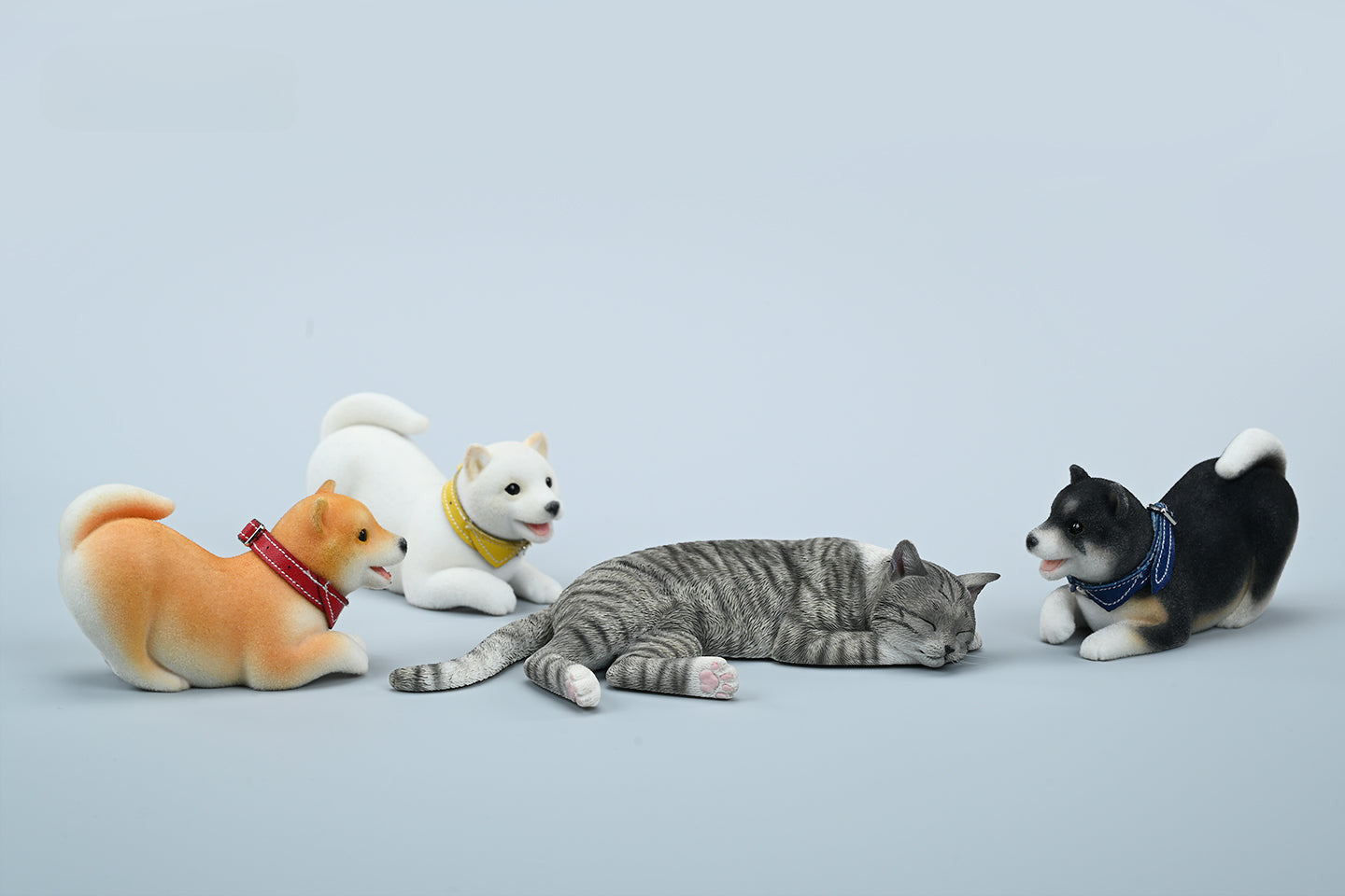 A set of three flocking Shiba Inu dog models in different colors - black, white, and tan. Each model features a realistic and adorable design with a collar in different colors: blue, yellow, and red. The dogs are shown in various poses, including waving, standing, and sitting.