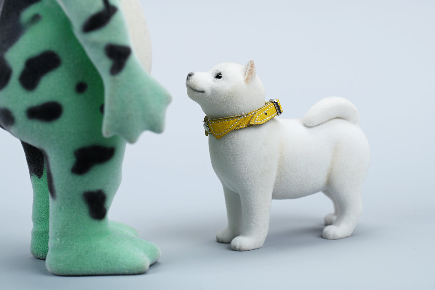 A set of three flocking Shiba Inu dog models in different colors - black, white, and tan. Each model features a realistic and adorable design with a collar in different colors: blue, yellow, and red. The dogs are shown in various poses, including waving, standing, and sitting.