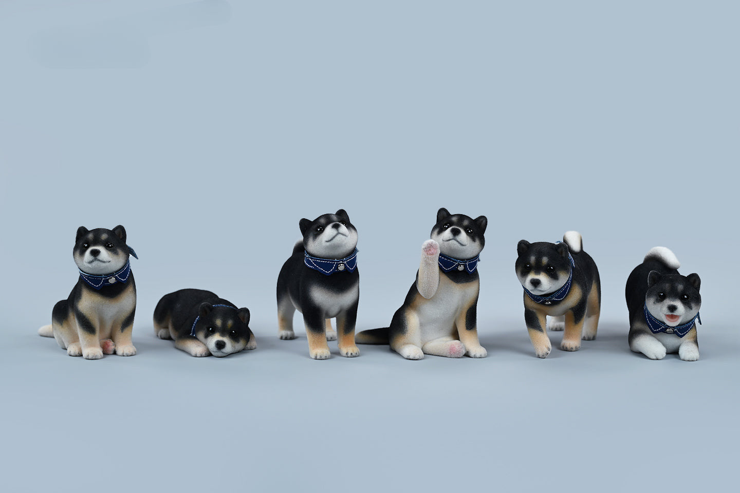 A set of three flocking Shiba Inu dog models in different colors - black, white, and tan. Each model features a realistic and adorable design with a collar in different colors: blue, yellow, and red. The dogs are shown in various poses, including waving, standing, and sitting.