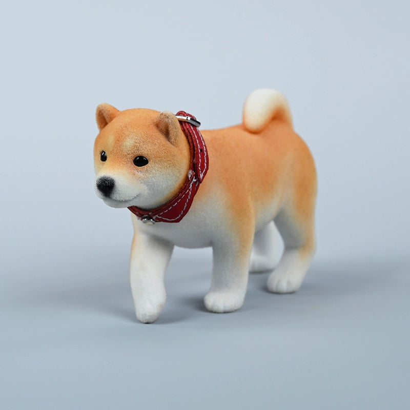 A set of three flocking Shiba Inu dog models in different colors - black, white, and tan. Each model features a realistic and adorable design with a collar in different colors: blue, yellow, and red. The dogs are shown in various poses, including waving, standing, and sitting.