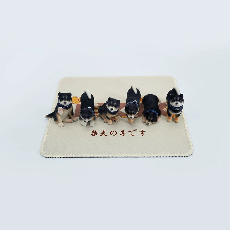 A set of three flocking Shiba Inu dog models in different colors - black, white, and tan. Each model features a realistic and adorable design with a collar in different colors: blue, yellow, and red. The dogs are shown in various poses, including waving, standing, and sitting.