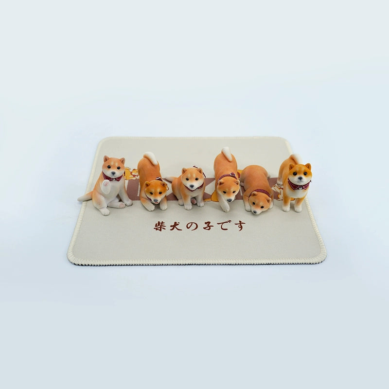 A set of three flocking Shiba Inu dog models in different colors - black, white, and tan. Each model features a realistic and adorable design with a collar in different colors: blue, yellow, and red. The dogs are shown in various poses, including waving, standing, and sitting.