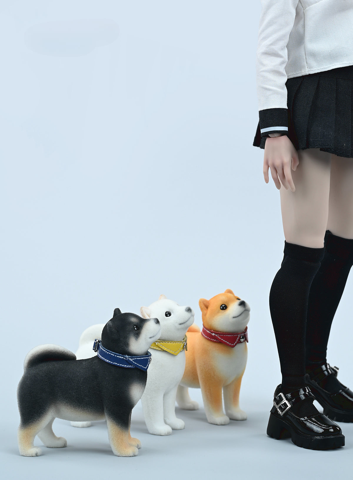 A set of three flocking Shiba Inu dog models in different colors - black, white, and tan. Each model features a realistic and adorable design with a collar in different colors: blue, yellow, and red. The dogs are shown in various poses, including waving, standing, and sitting.