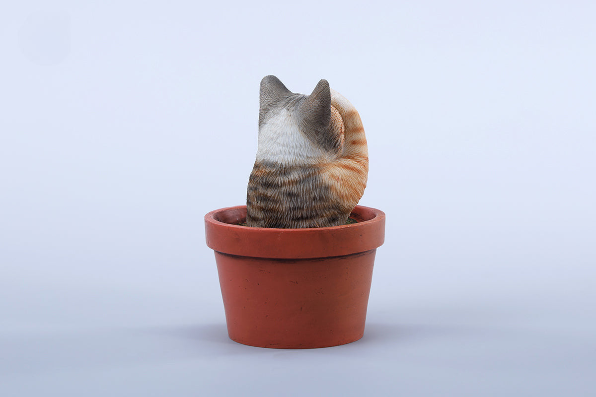 This charming Flower Pot Cat Model features a playful kitten peeking out of a terracotta pot with a small yellow rubber duck on its head. The series includes multiple variations, each with a different accessory atop the cat's head. This delightful ornament brings a touch of whimsy and cheer to any space, perfect for cat lovers and collectors alike. The detailed craftsmanship and vibrant colors make it a standout piece in any collection.