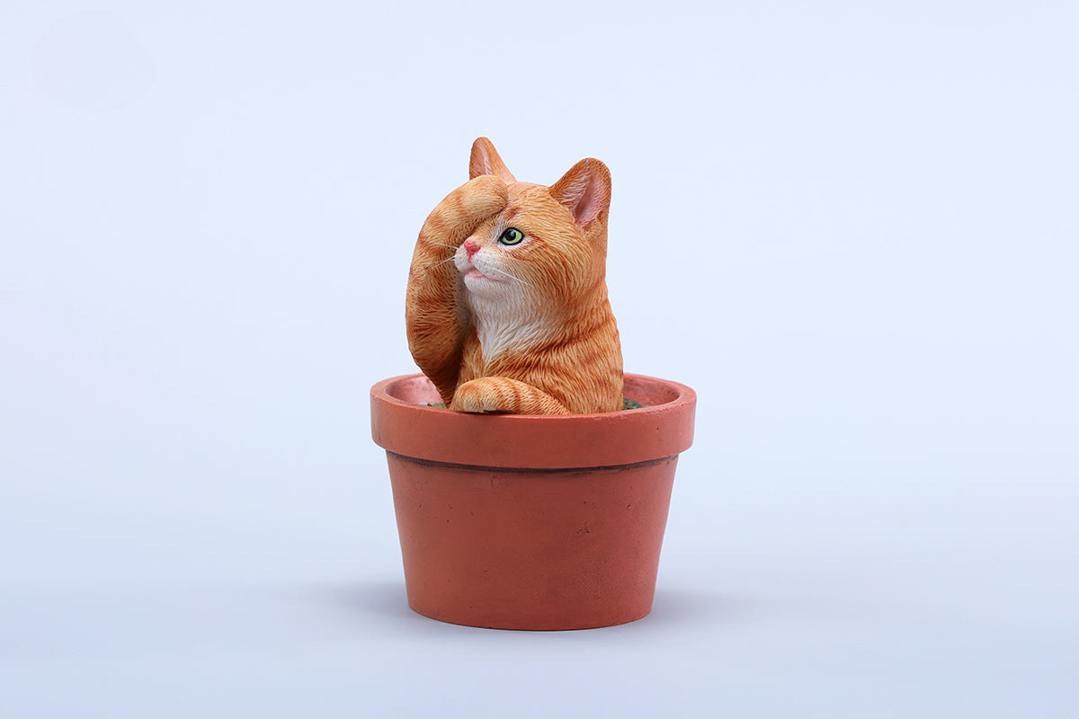 This charming Flower Pot Cat Model features a playful kitten peeking out of a terracotta pot with a small yellow rubber duck on its head. The series includes multiple variations, each with a different accessory atop the cat's head. This delightful ornament brings a touch of whimsy and cheer to any space, perfect for cat lovers and collectors alike. The detailed craftsmanship and vibrant colors make it a standout piece in any collection.