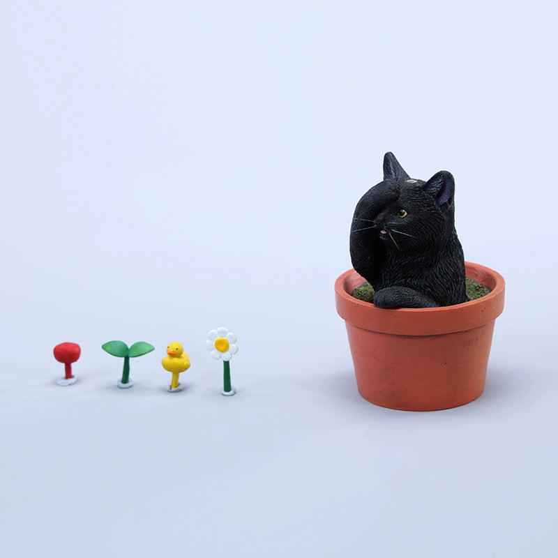 This charming Flower Pot Cat Model features a playful kitten peeking out of a terracotta pot with a small yellow rubber duck on its head. The series includes multiple variations, each with a different accessory atop the cat's head. This delightful ornament brings a touch of whimsy and cheer to any space, perfect for cat lovers and collectors alike. The detailed craftsmanship and vibrant colors make it a standout piece in any collection.