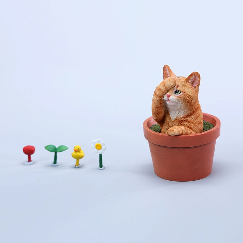 This charming Flower Pot Cat Model features a playful kitten peeking out of a terracotta pot with a small yellow rubber duck on its head. The series includes multiple variations, each with a different accessory atop the cat's head. This delightful ornament brings a touch of whimsy and cheer to any space, perfect for cat lovers and collectors alike. The detailed craftsmanship and vibrant colors make it a standout piece in any collection.