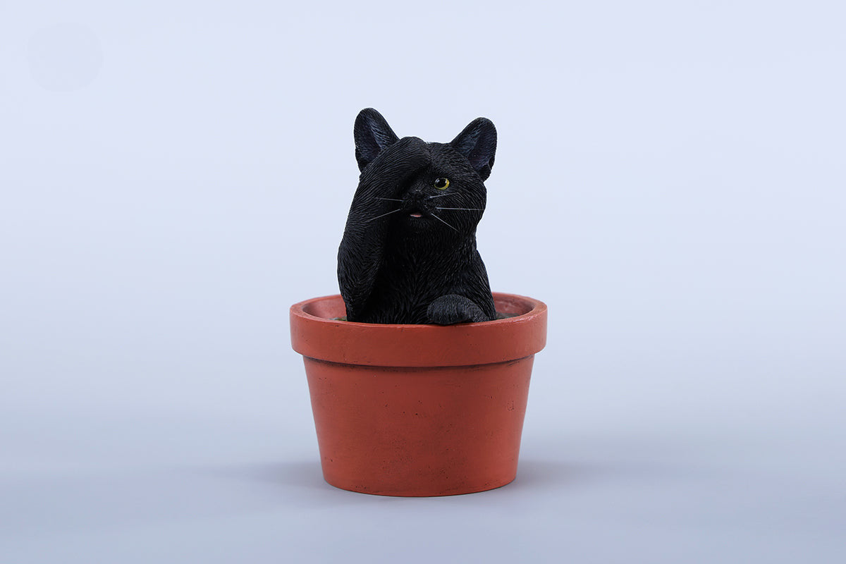 This charming Flower Pot Cat Model features a playful kitten peeking out of a terracotta pot with a small yellow rubber duck on its head. The series includes multiple variations, each with a different accessory atop the cat's head. This delightful ornament brings a touch of whimsy and cheer to any space, perfect for cat lovers and collectors alike. The detailed craftsmanship and vibrant colors make it a standout piece in any collection.