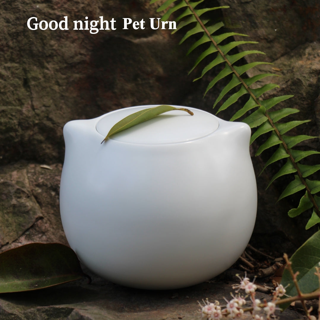 The Good Night Pet Memorial Set (Dog) includes a white ceramic pet urn with a silicone-sealed lid, dog shrine, bone candle set, and hair storage box, measuring 15cm tall and 10cm wide, holding 200ml for pets up to 25 pounds. Ideal for North American dog owners, it offers a warm, handcrafted memorial display for shelves or tables.