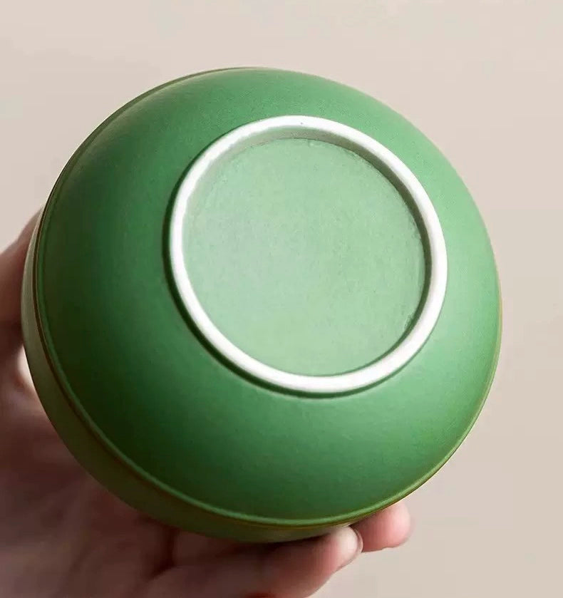 This green panda pet urn showcases a cute round ceramic design with a playful panda figurine on top, measuring 12.5cm wide, 11cm tall, and 9.1cm in diameter, holding 290ml of ashes. Ideal for North American pet owners honoring small pets like cats or dogs, it offers secure storage and a warm memorial display, fitting perfectly on shelves or mantels.