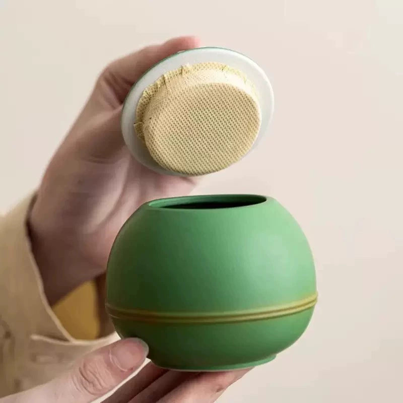 This green panda pet urn showcases a cute round ceramic design with a playful panda figurine on top, measuring 12.5cm wide, 11cm tall, and 9.1cm in diameter, holding 290ml of ashes. Ideal for North American pet owners honoring small pets like cats or dogs, it offers secure storage and a warm memorial display, fitting perfectly on shelves or mantels.