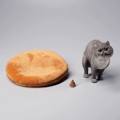 A detailed resin model of a Garfield cat in a half-squat position, poised above a plush bed. The cat, rendered with realistic fur texture and markings, appears lifelike and is captured mid-action. The scene includes a playful addition, making it an amusing piece for collectors and cat lovers alike.
