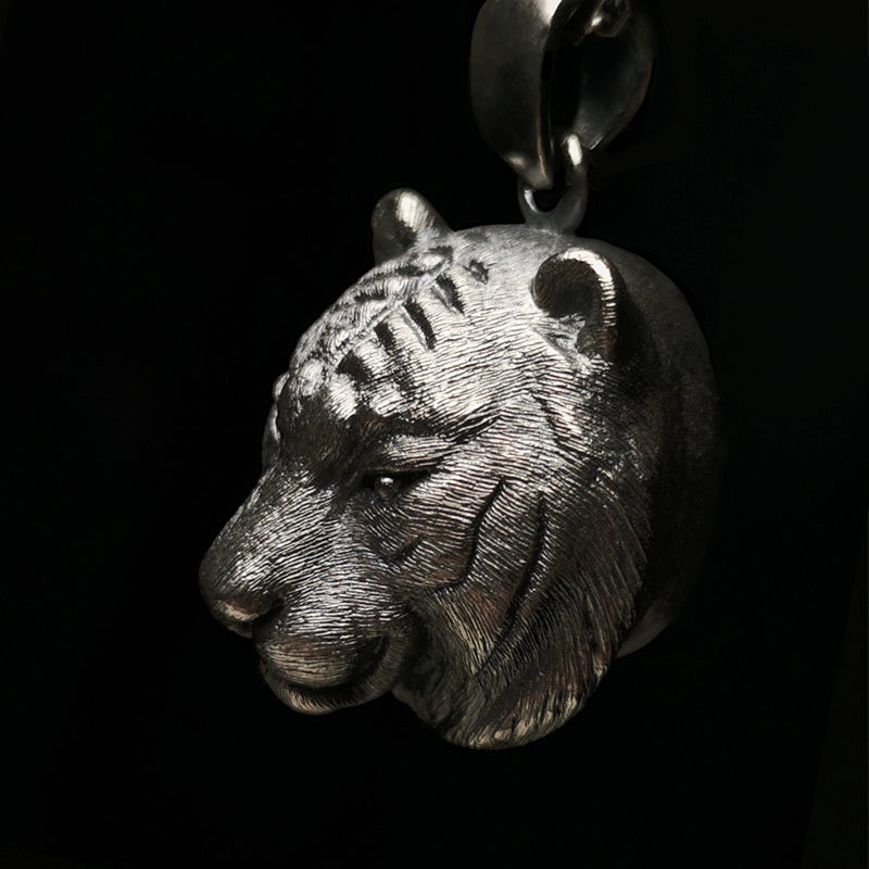 A meticulously handcrafted 925 silver tiger pendant featuring intricate fur details and gemstone eyes, available in both silver and antique black finishes. Perfect for pet memorials or as a symbol of strength.