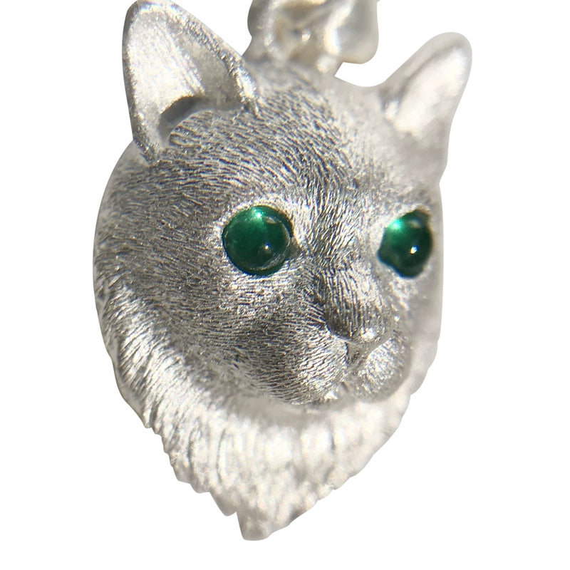 A handcrafted sterling silver cat pendant with customizable gemstone eyes, perfect for pet lovers. This unique piece of jewelry serves as a cherished reminder of your beloved feline friend.