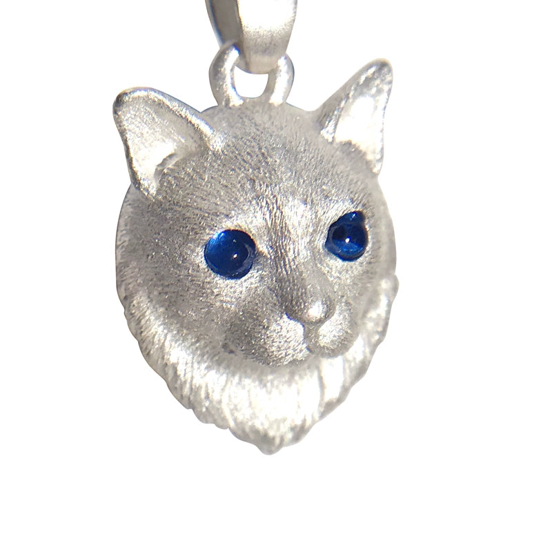 A handcrafted sterling silver cat pendant with customizable gemstone eyes, perfect for pet lovers. This unique piece of jewelry serves as a cherished reminder of your beloved feline friend.